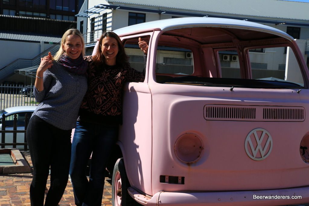 girls by a pink VW