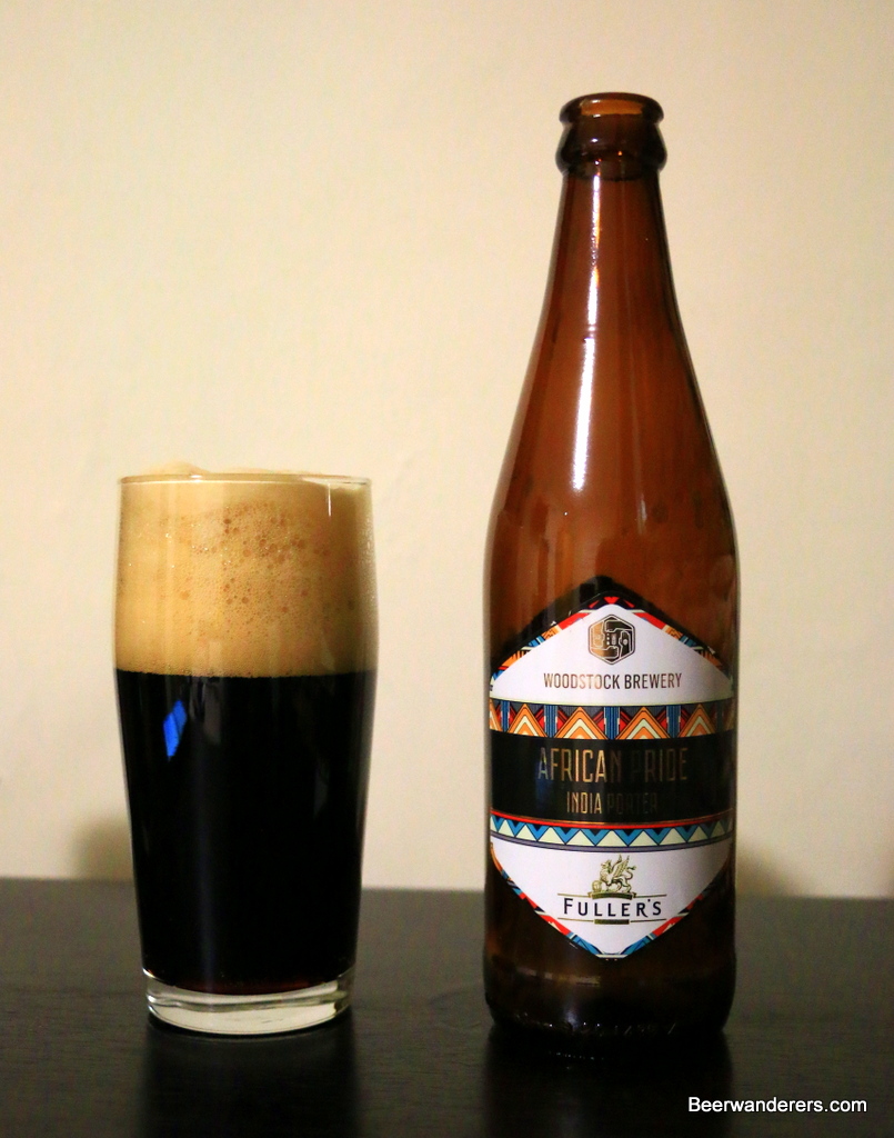 black beer in glass with bottle